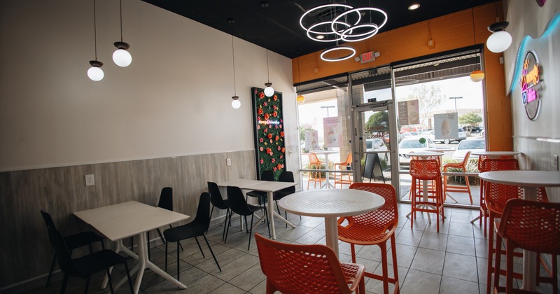 Interior with bar and regular tables, stools and chairs
