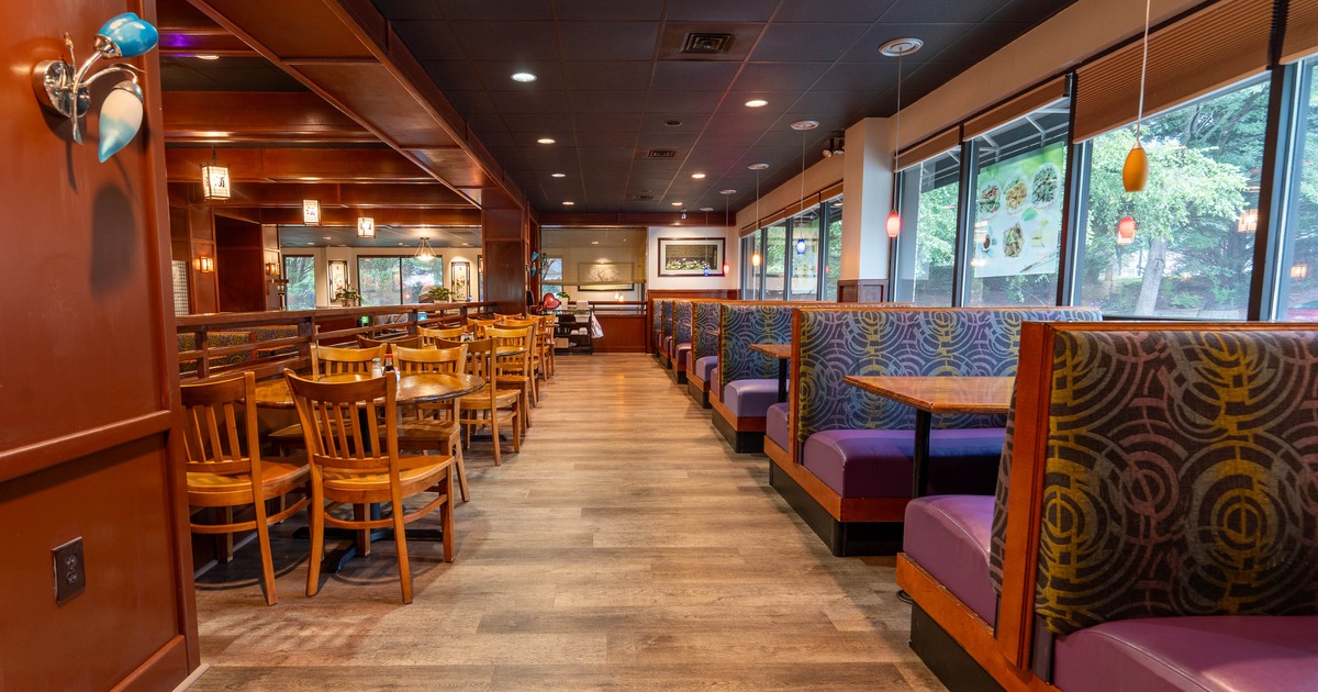 Interior, dining area, tables with wooden chairs, seating booths by the windows