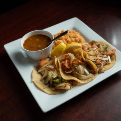 City Chicken Tacos served with rice and dip.