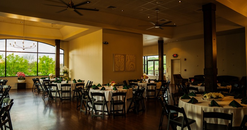 Interior, large dining area with large windows and fans on the ceiling