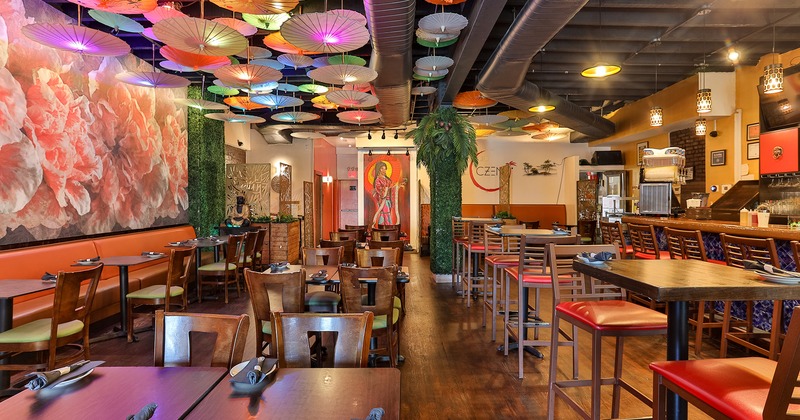 Interior space, dining area with set tables, Japanese parasols hanging from the ceiling
