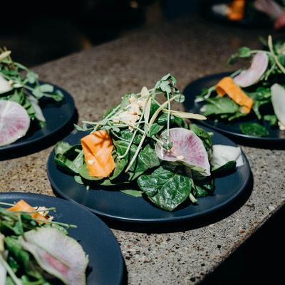 Plated salads on a counter.