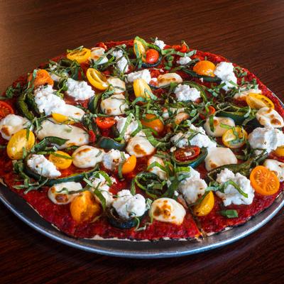 The Catania Pizza topped with dollops of ricotta, cherry tomatoes, peppers and basil.