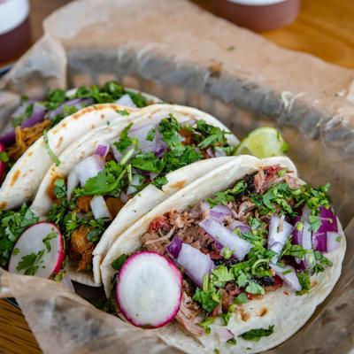 Street tacos, with onion, cilantro, and radish.