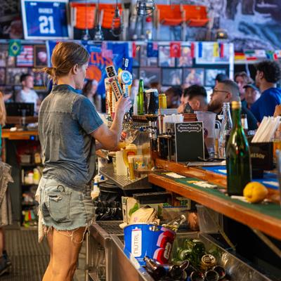 Bartender serving guests at the bar.