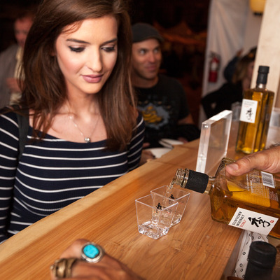 Bartender serving Japanese whiskey to a customer.
