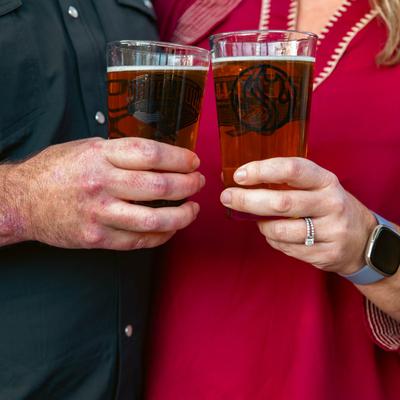 Hands making a toast with their drinks.