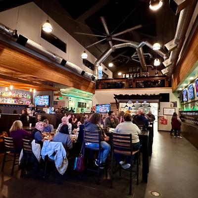 Hop Thief Taphouse and Kitchen interior, guests in seating area.