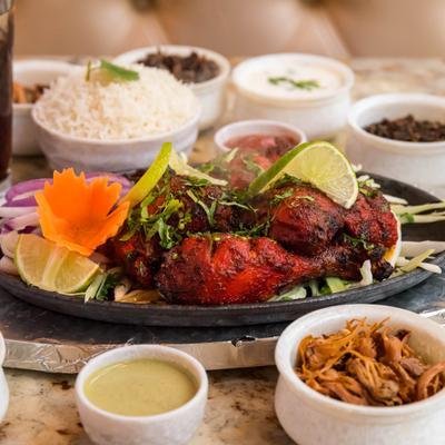 Tandoor Chicken, served with other dishes.