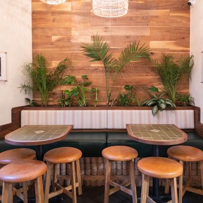 Seating area banquette seating, tables, and stools.