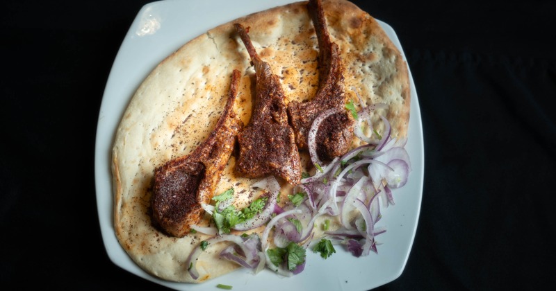 Lamb chops on naan bread with onions