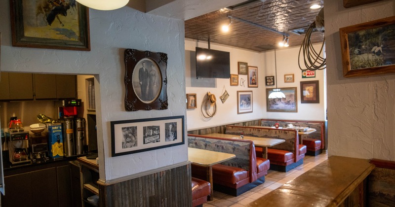 Interior, coffee station, red booths, and vintage photographs on the walls