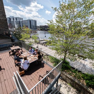 Exterior, guests sitting on the terrace, view of the river