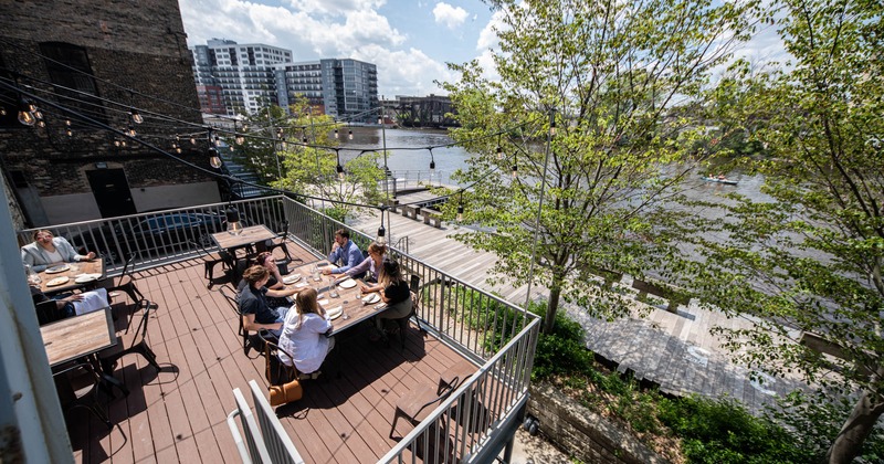 Exterior, view of guests dining on the terrace, angle view