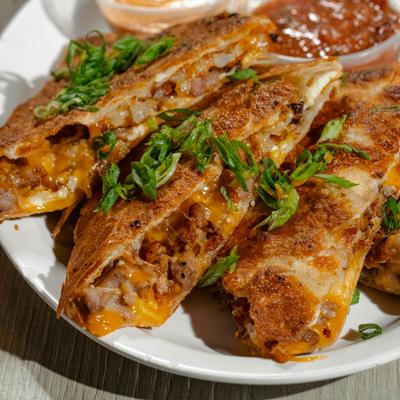 Quesadillas, with eggs, cheese, sausage, and bacon.