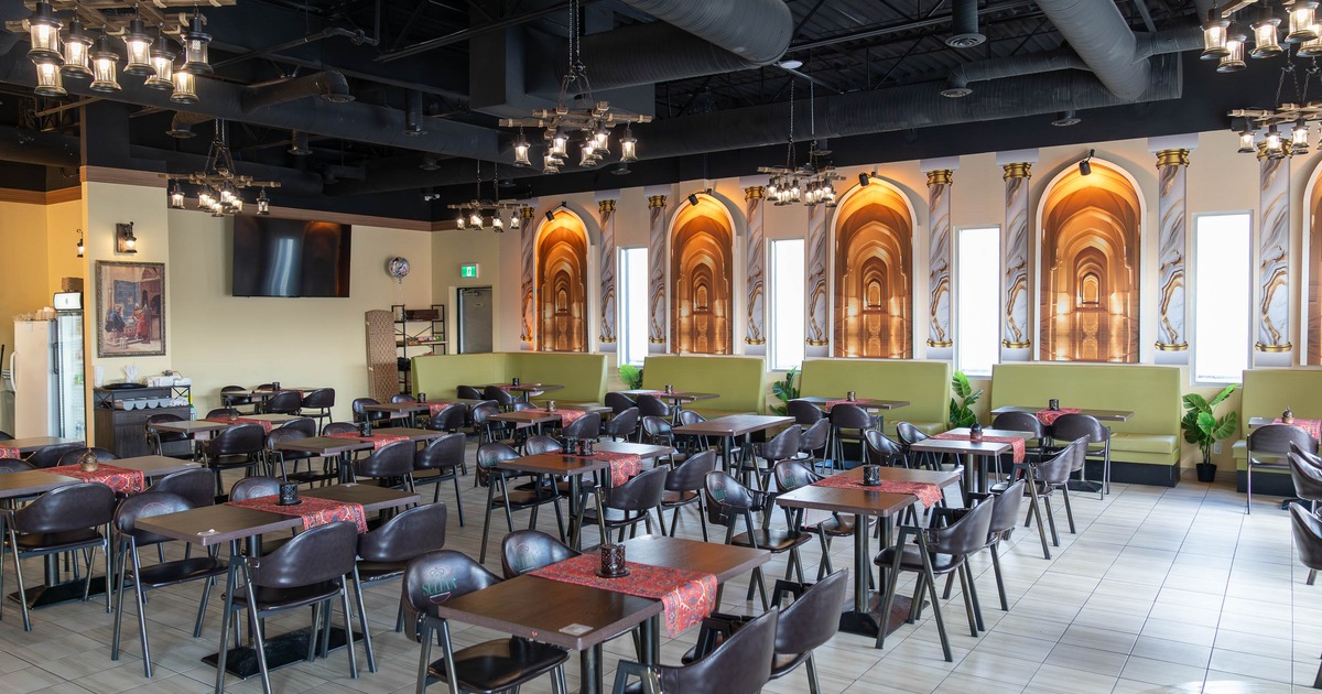 Spacious dining area with arranged tables and chairs