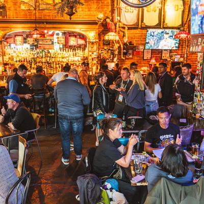 Crowded interior, customers having drinks.
