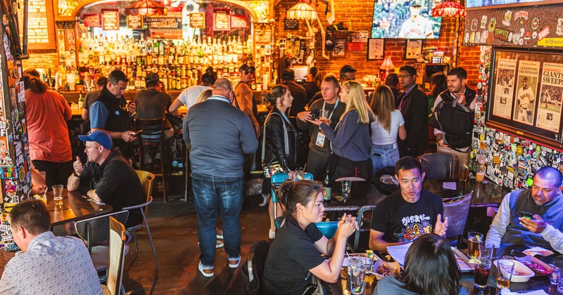 Crowded interior, customers having drinks