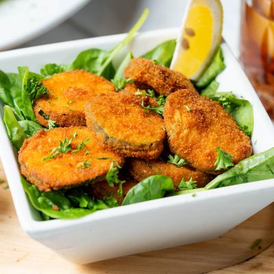 Fried zucchini on top of greens