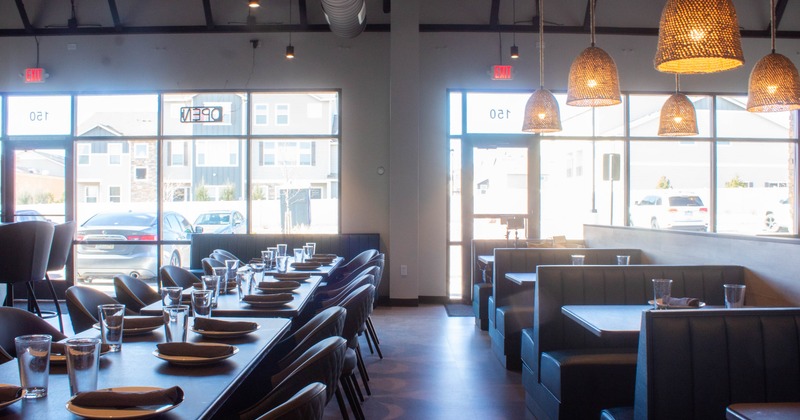 Interior, dining area, large shop windows, restaurant entrance, tables with chairs, booths