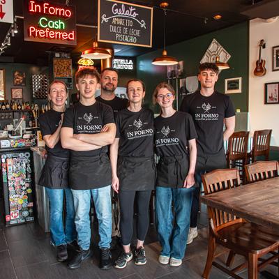Group of staff members posing inside a restaurant.