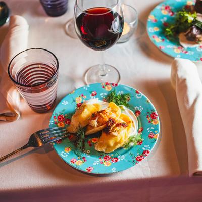 Yuca Pierogi plate accompanied with red wine.