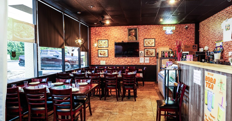 Interior, dining area, table setups for six and ten people, ready for guests, shop window