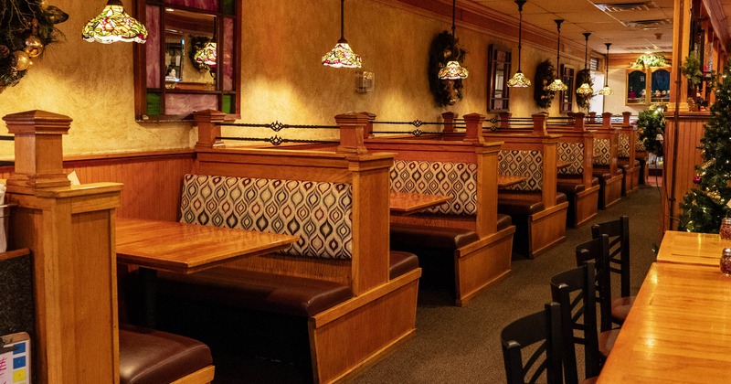 Dining area with wooden booths and stained glass pendant lights