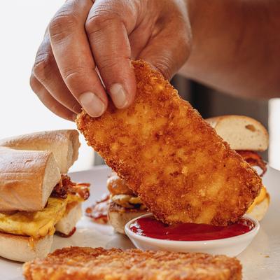 A hand dipping food.