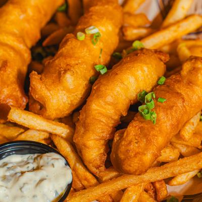 Fish and Chips with tartar sauce on the side, close-up.