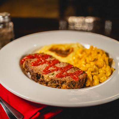 Meatloaf, served with mac and cheese, and mashed potatoes and gravy.
