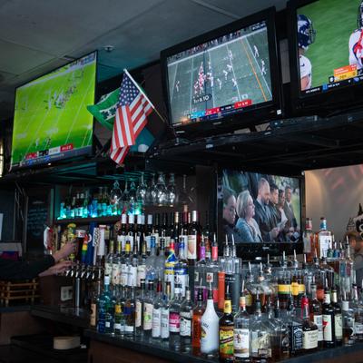 Bar, bottles of spirits and TVs.