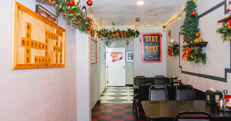 Cozy, festive diner interior with Christmas garlands and red ornaments