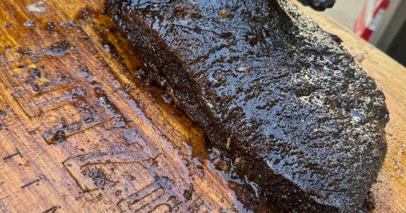 Smoked meat ready for slicing on a slab