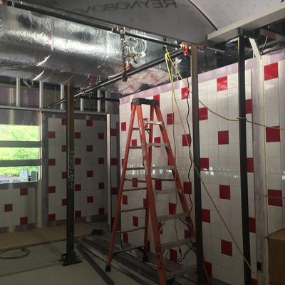 A room with red and white tiles and a ladder