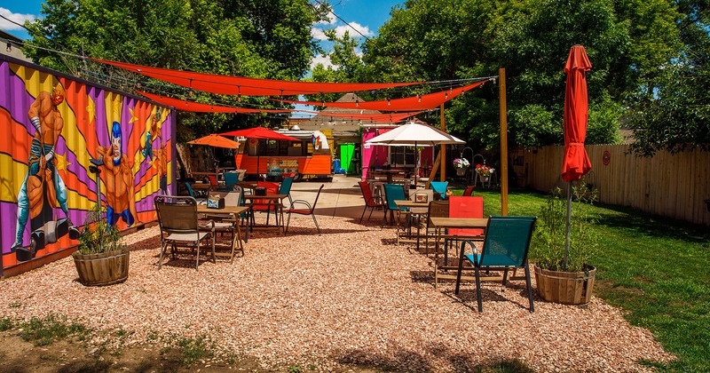 Courtyard with tables, chairs and sunshades umbrellas