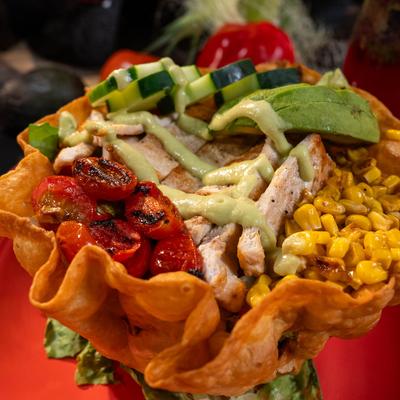 Chicken taco salad in a crispy tortilla bowl.