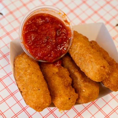 Mozzarella sticks served with marinara sauce.