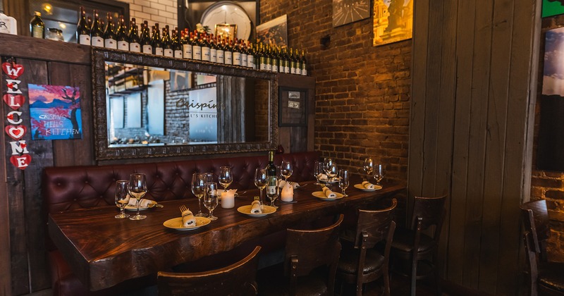 Restaurant interior, dining table in the corner set up for eight guests