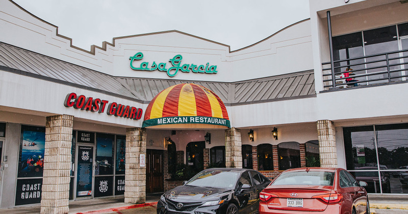 Casa Garcia Mexican Restaurant exterior with a striped awning and parked cars