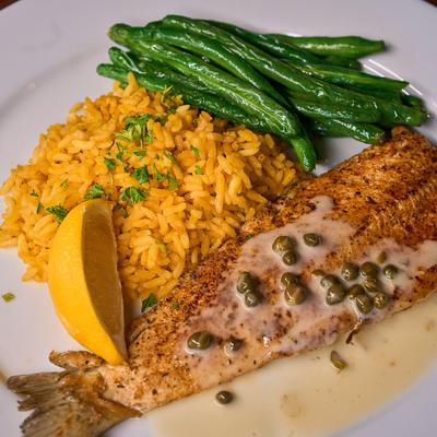 Blackened rainbow trout with capers, rice, and green beans.
