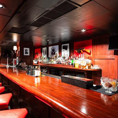 Bar seating area with photos on the wall.