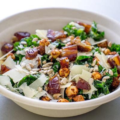 Dressed Kale salad with dates, parmesan, spiced chickpeas and sunflower seed.