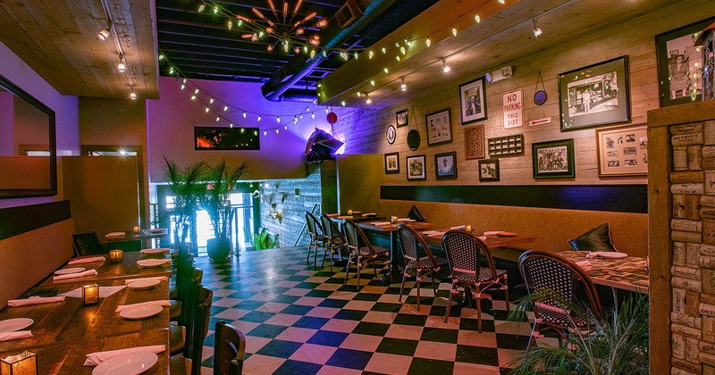 Interior, tables ready for guests, old photos on the wall