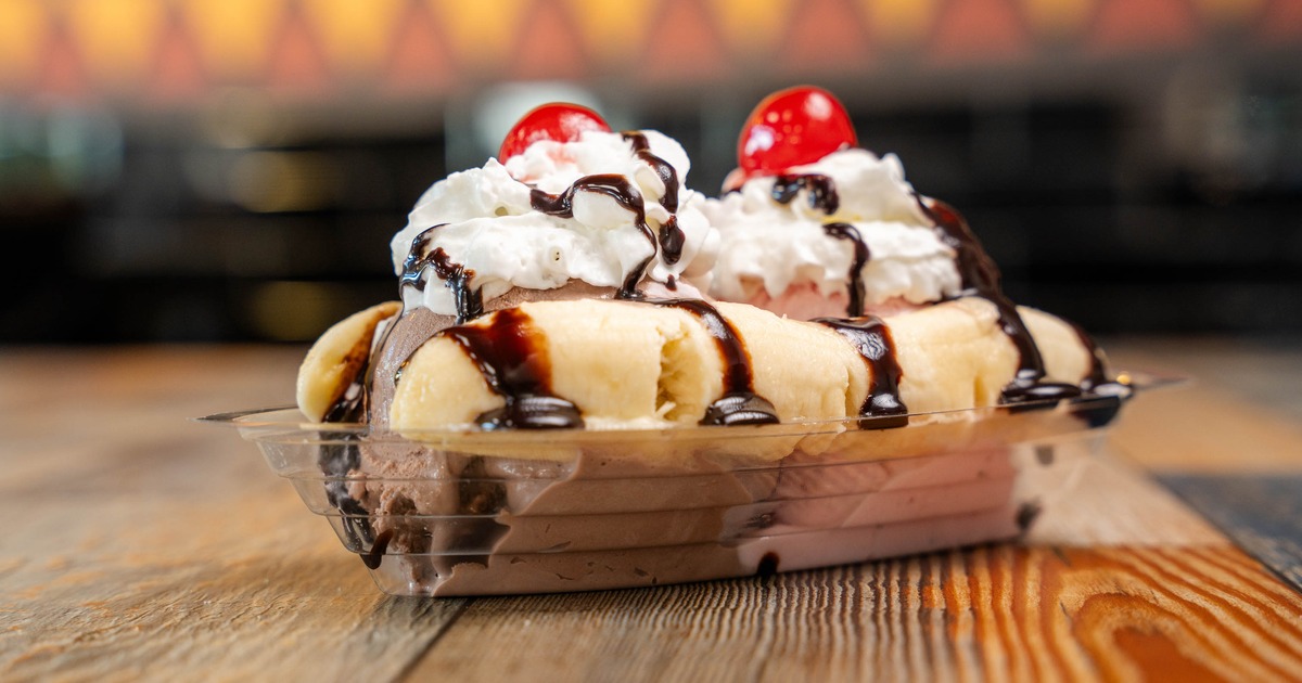 Banana split ice cream dessert served in a plastic container