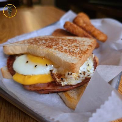 Breakfast sandwich with side, closeup.