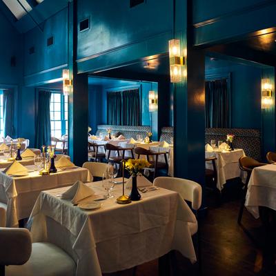 Upscale dining area with softly lit tables.