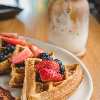 Classic waffle topped with strawberries and blueberries, closeup