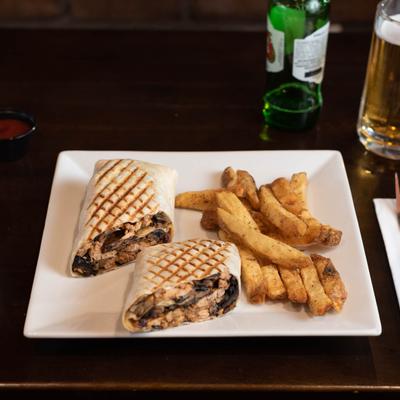 Toasted wrap with mushrooms and a side of fried sweet potatoes.