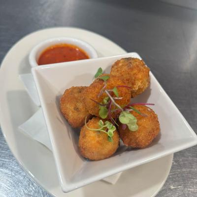Fried meatballs with marinara sauce.